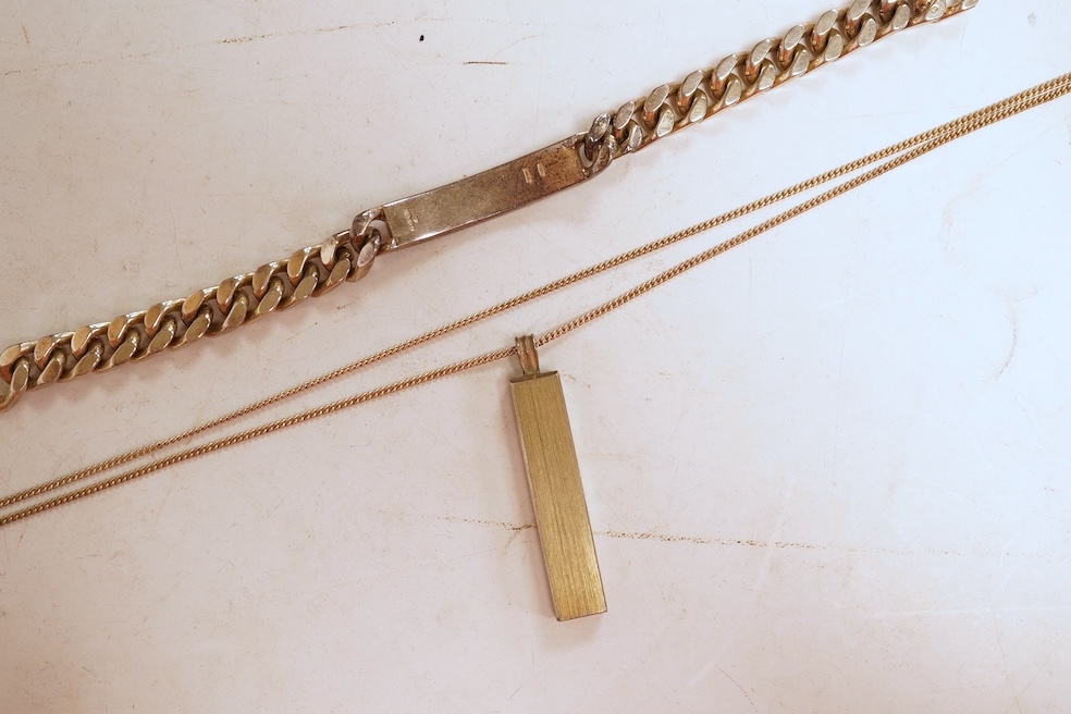 A silver necklace and bracelet, comprising: a silver ingot pendant necklace, pendant length 5.2cm including bail; and a silver curb link ID bracelet, length 20cm, each with British hallmarks, combined gross weight 82 gra